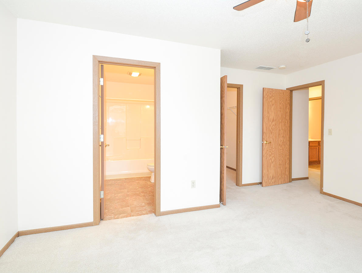 Bedroom Featuring Attached Bathroom & Walk-In Closet