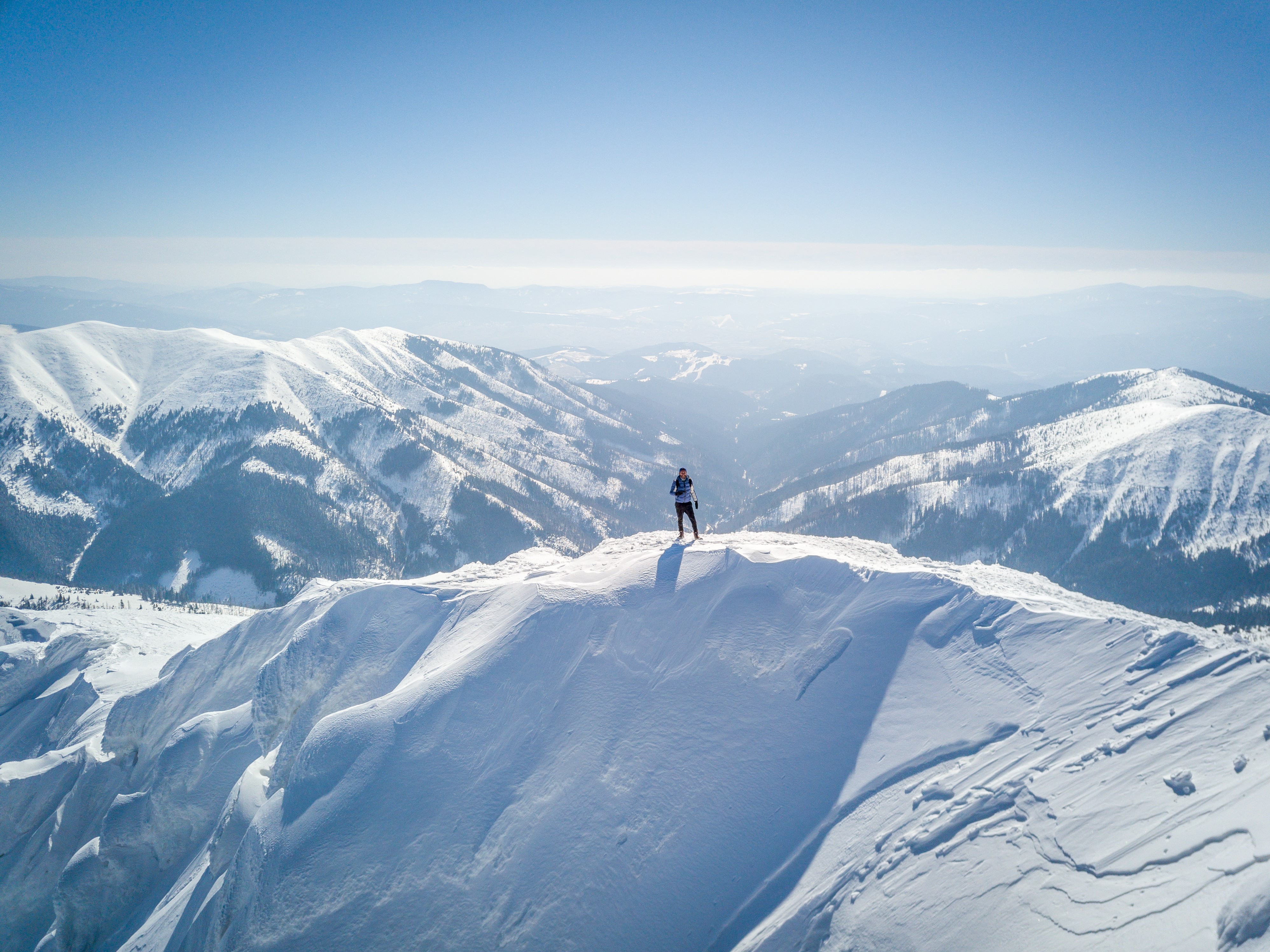 Man standing on top of snowy mountain (1).jpg