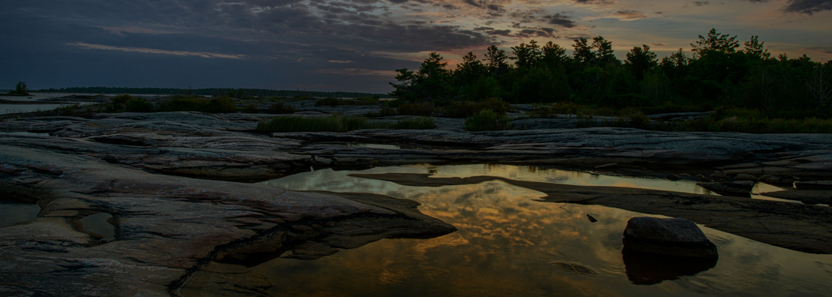 Reflective tide pools at dusk.
