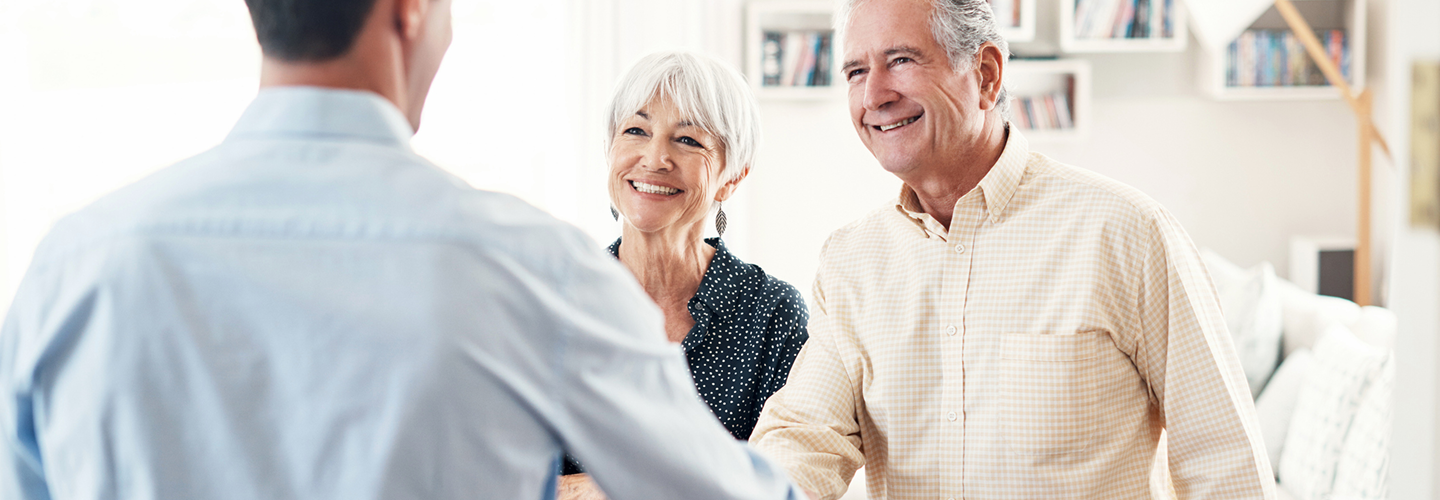 A wealth professional greeting his clients.