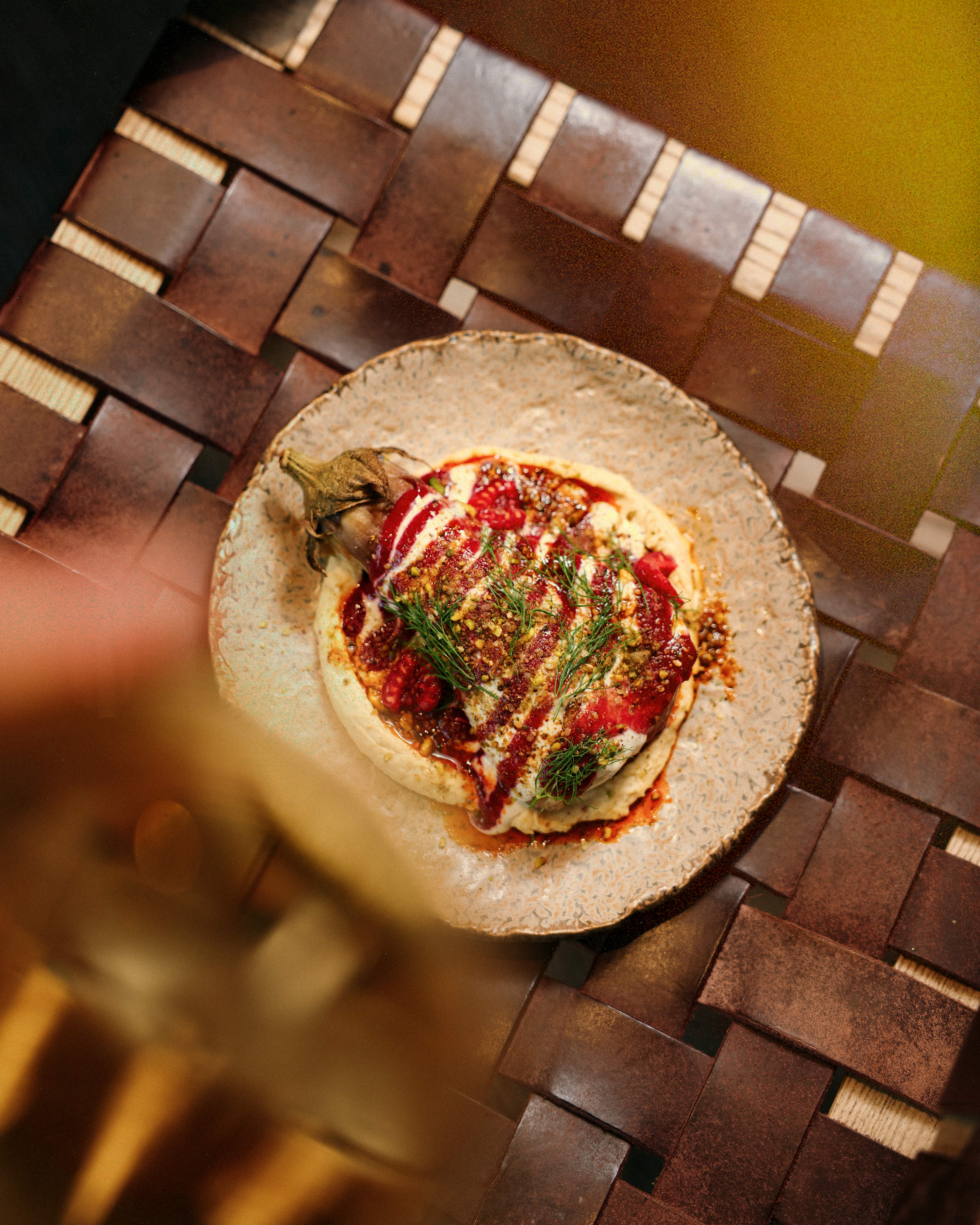 Raspberry Harissa Aubergine with raspberries, tahini dressing and herbs.