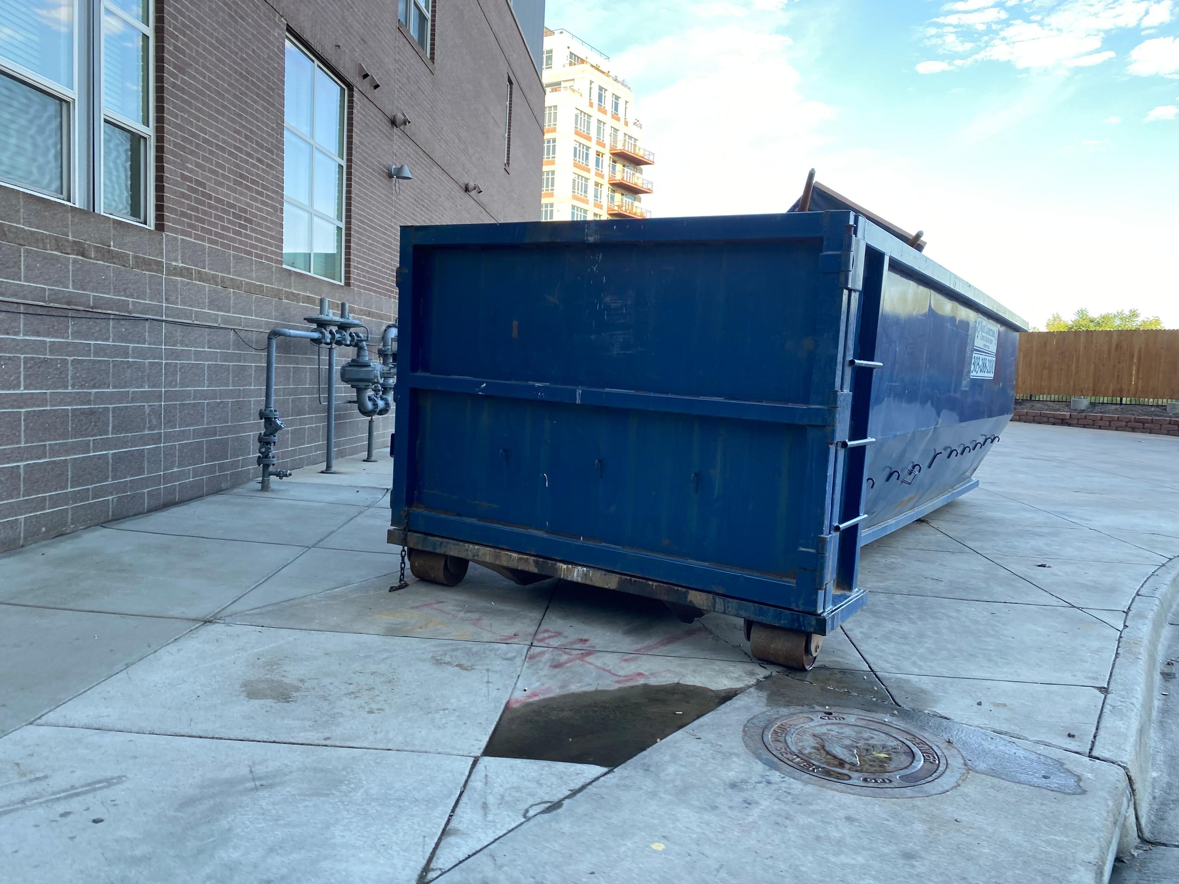 Blue dumpster roll off dumpster rental in downtown Denver, CO