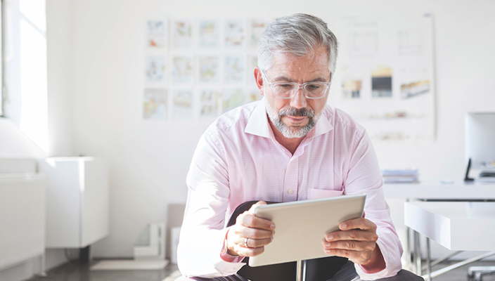 A client reviewing his accounts on his tablet.