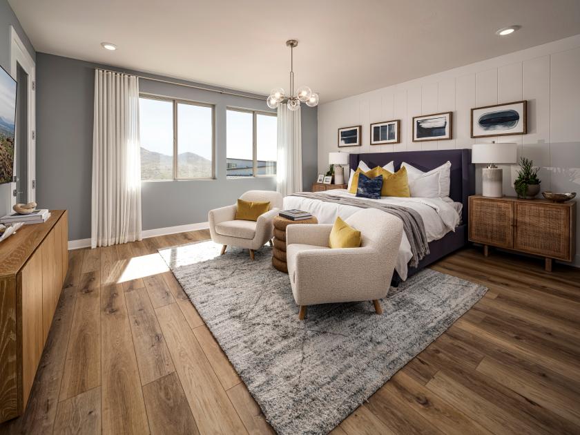 Primary bedroom suite with beautiful floors and striking accent wall