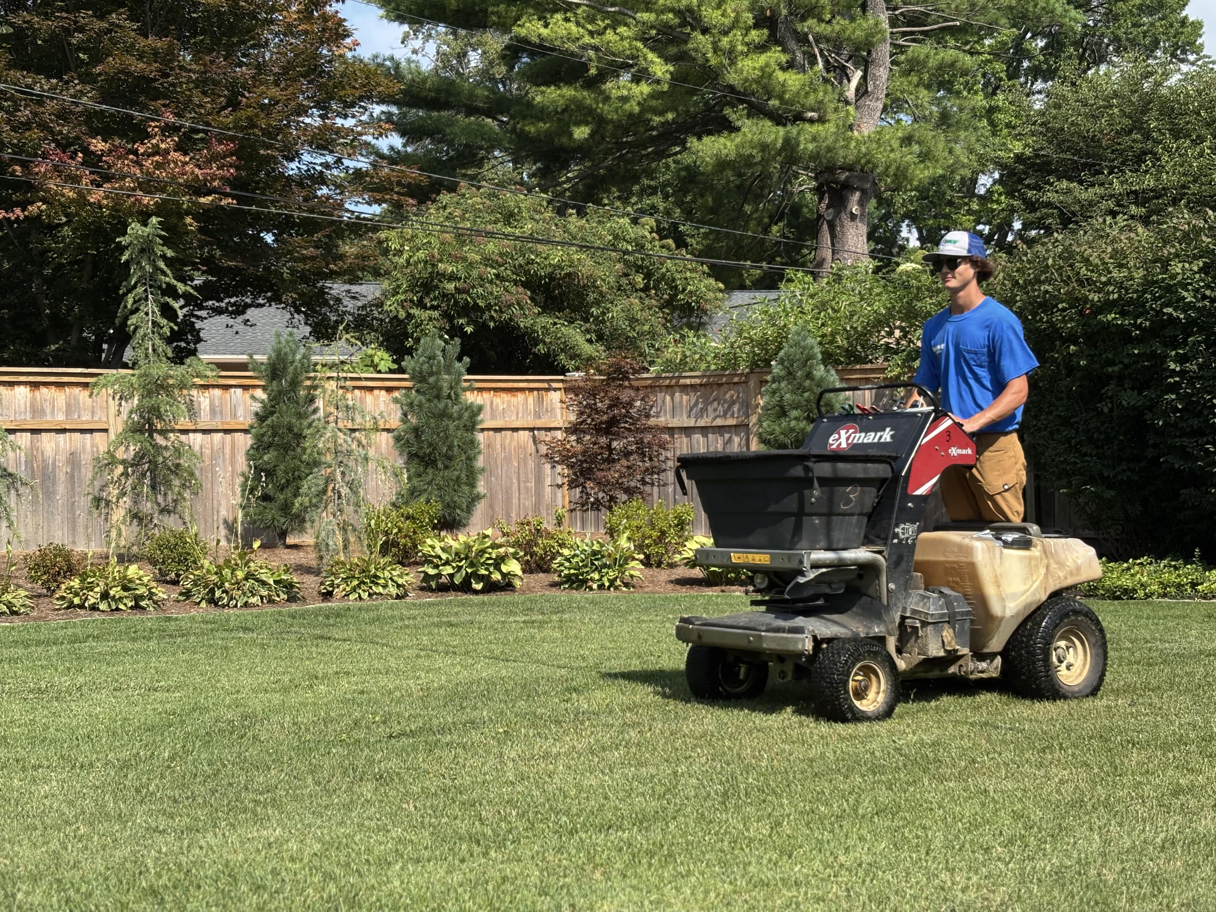 Matt’s Turf and more — Evansville, IN — a team member maintains a residential lawn using professional mowing equipment as part of the company’s landscaping services.