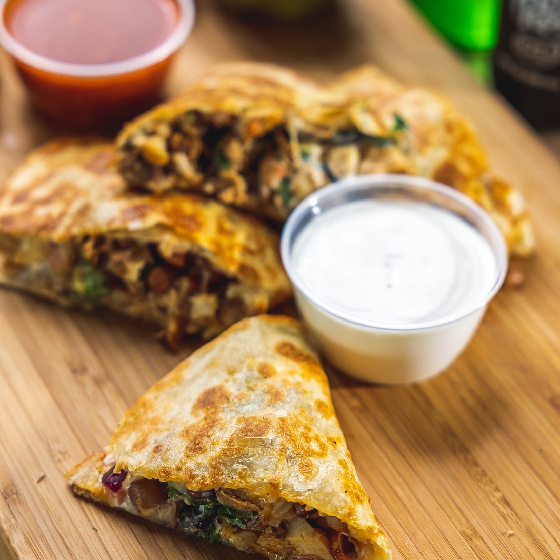 quesadilla with queso on the side and red salsa
