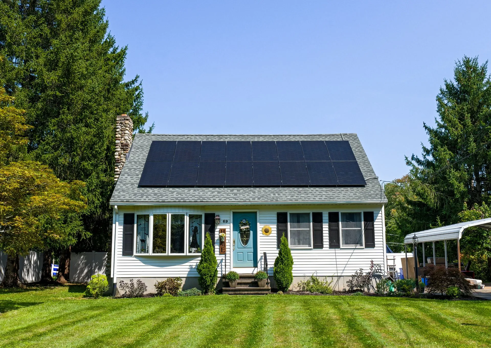 White home with a full rooftop solar panel system