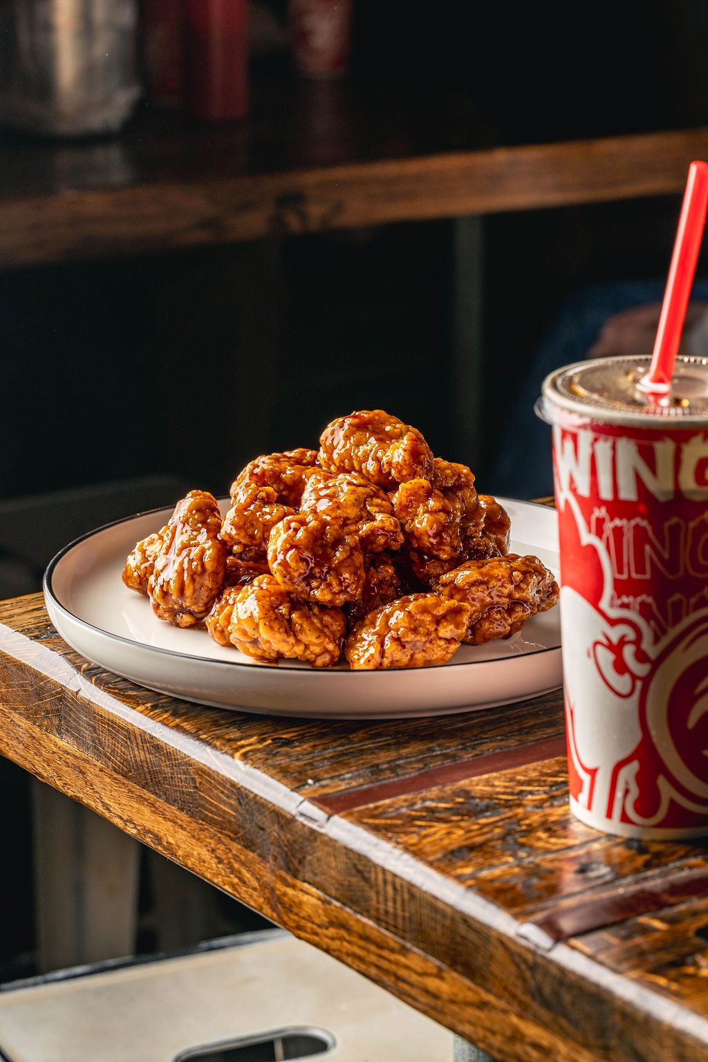 A plate of boneless wings tossed in BBQ sauce