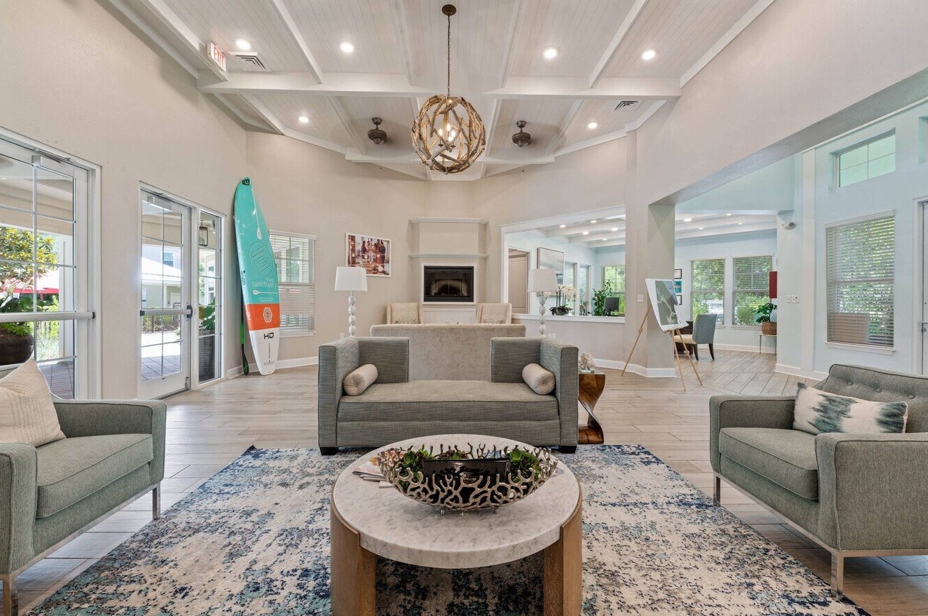 A bright and stylish clubhouse lounge with modern seating and coastal design accents.