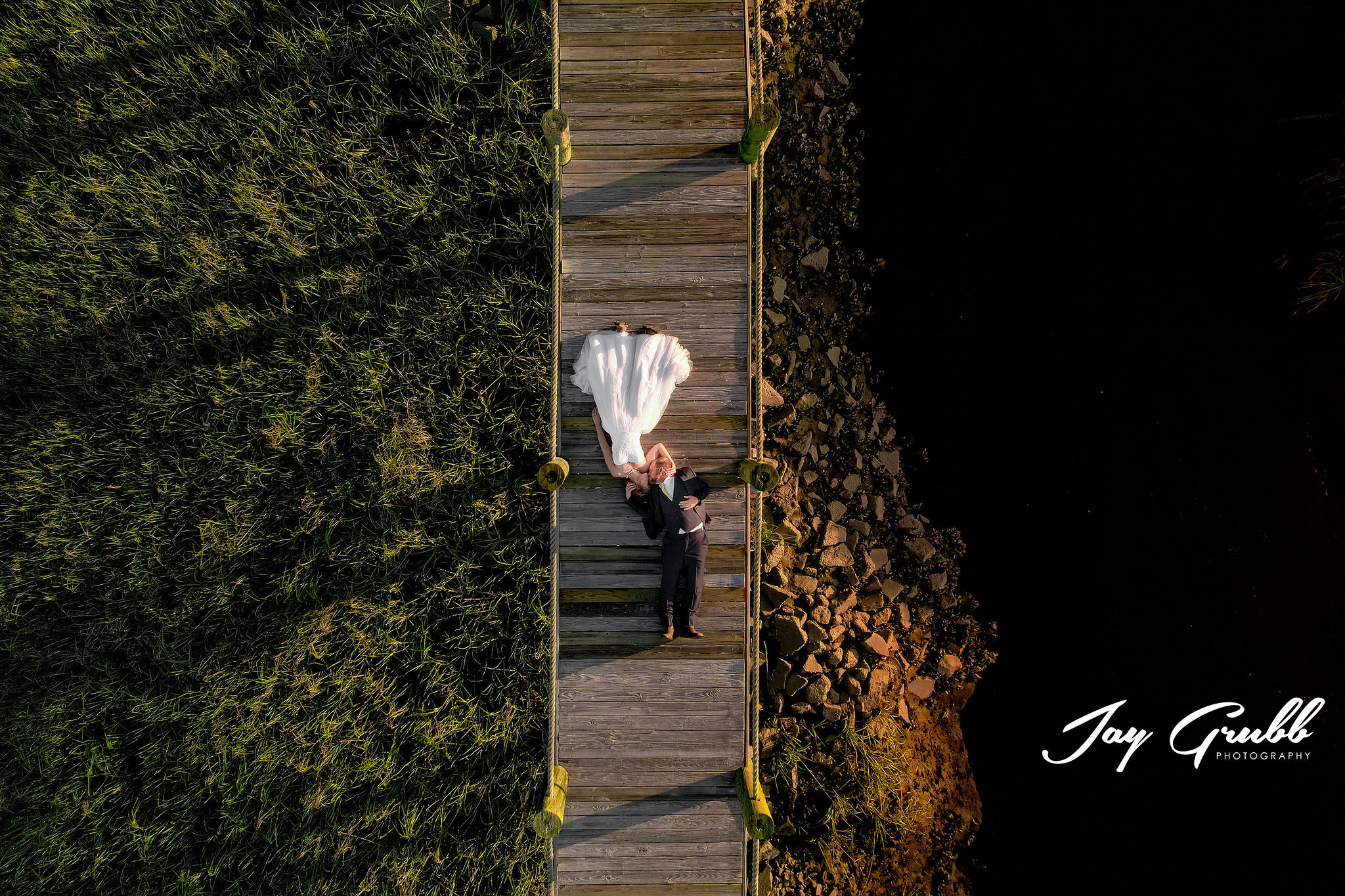 drone photo of couple on dock 