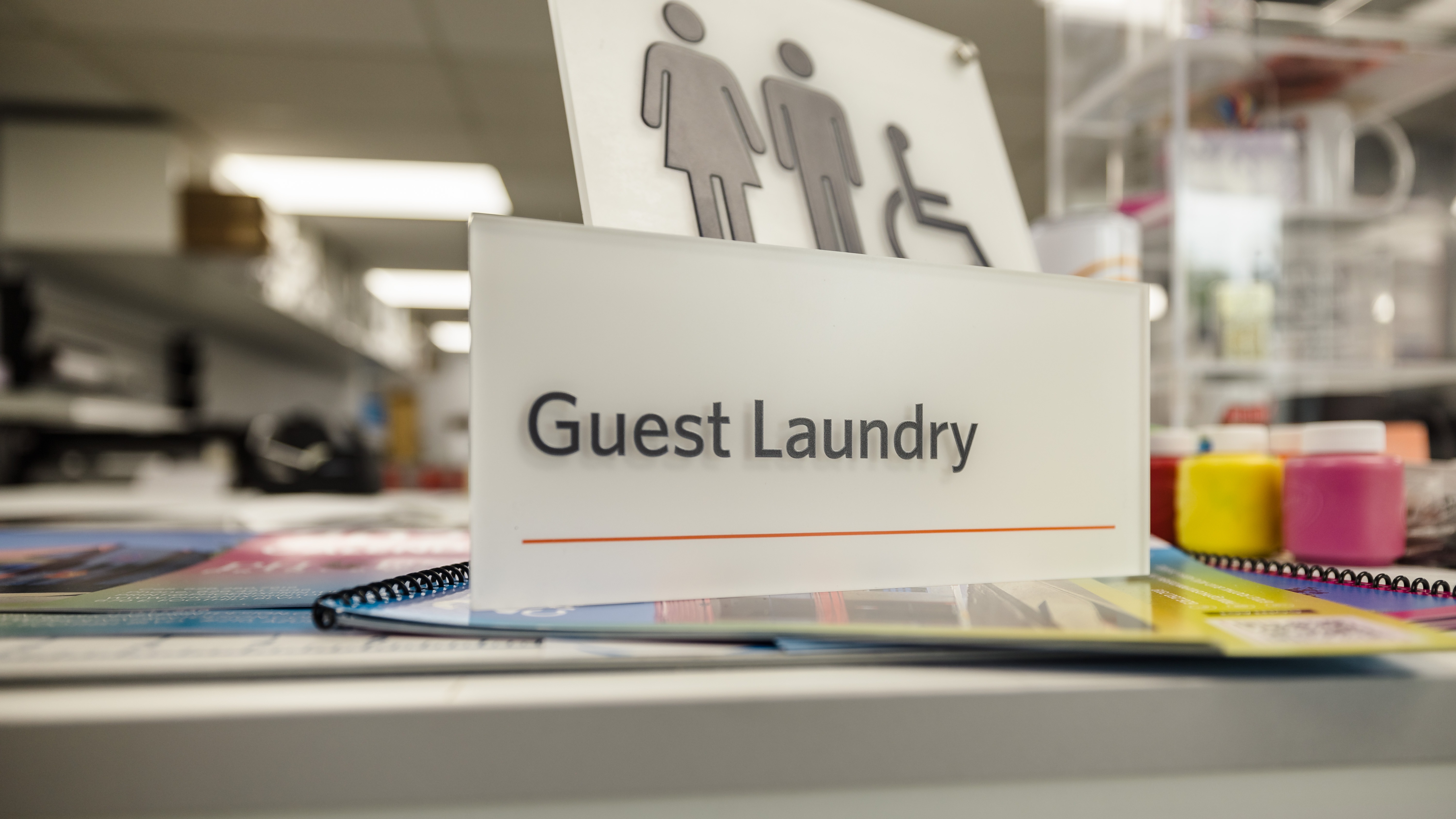 Plastic printed sign that says Guest Laundry