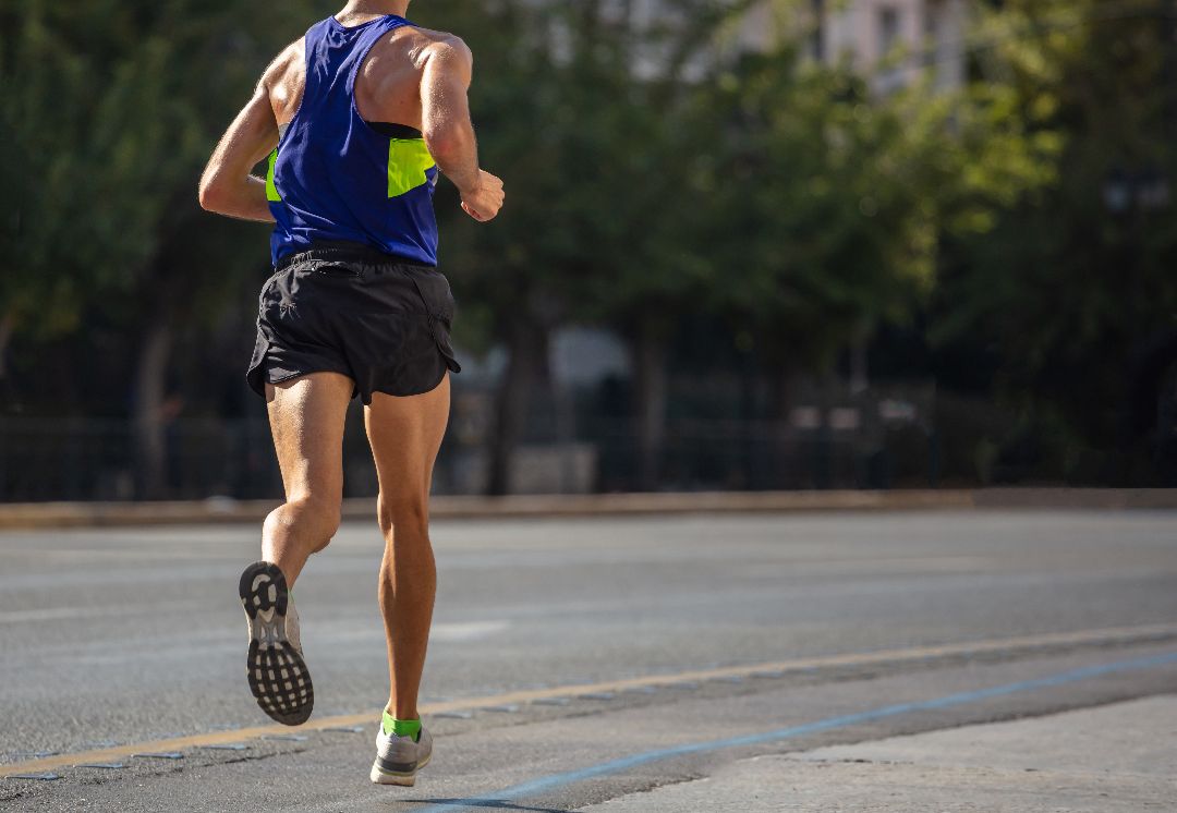 running-city-roads-young-man-runner-back-view-blur-background.jpg