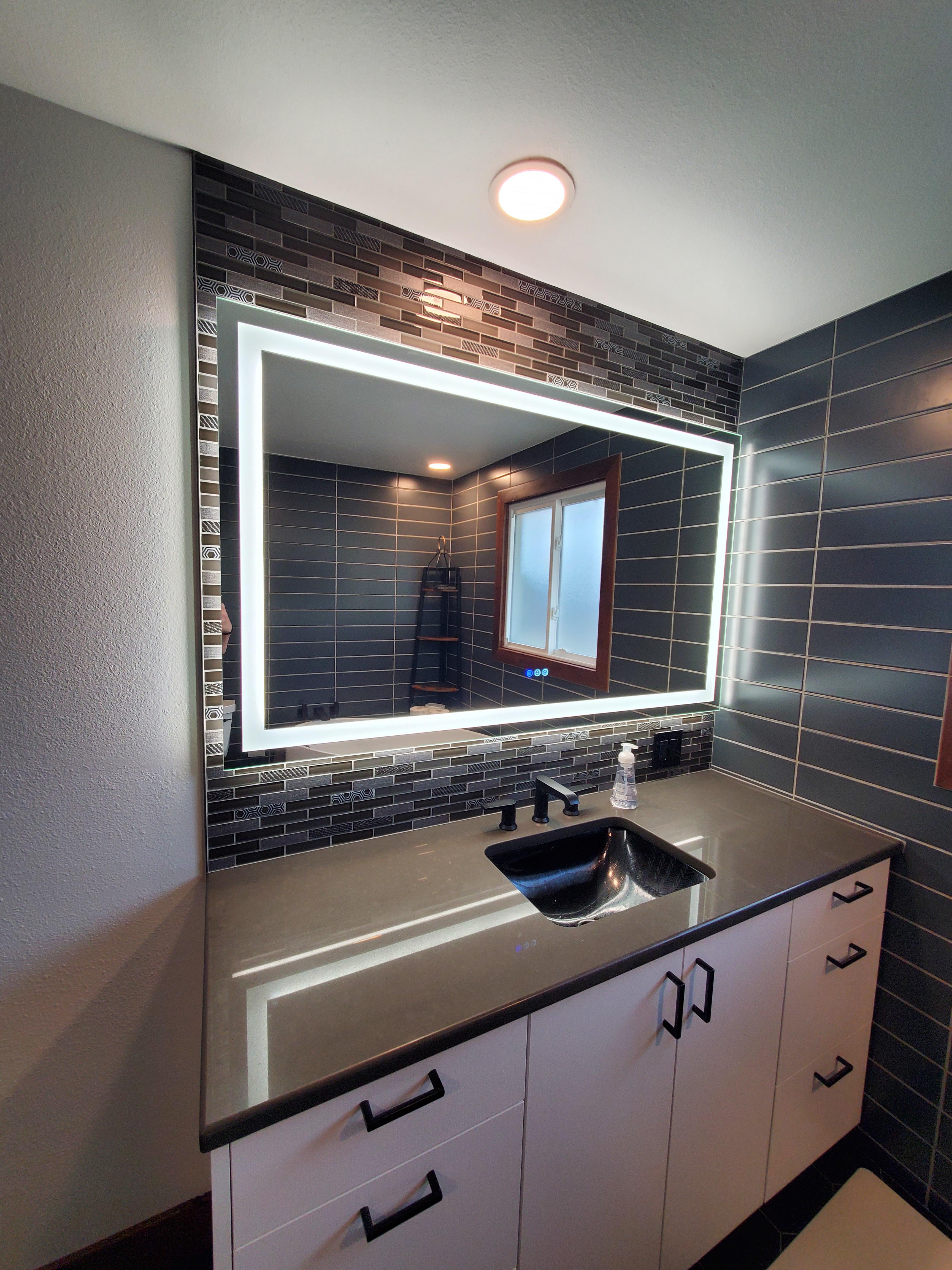 This lighted mirror makes the beautiful tile in the bathroom glow! DreamMaker Bath & Kitchen of Larimer County Fort Collins (970)616-0900
