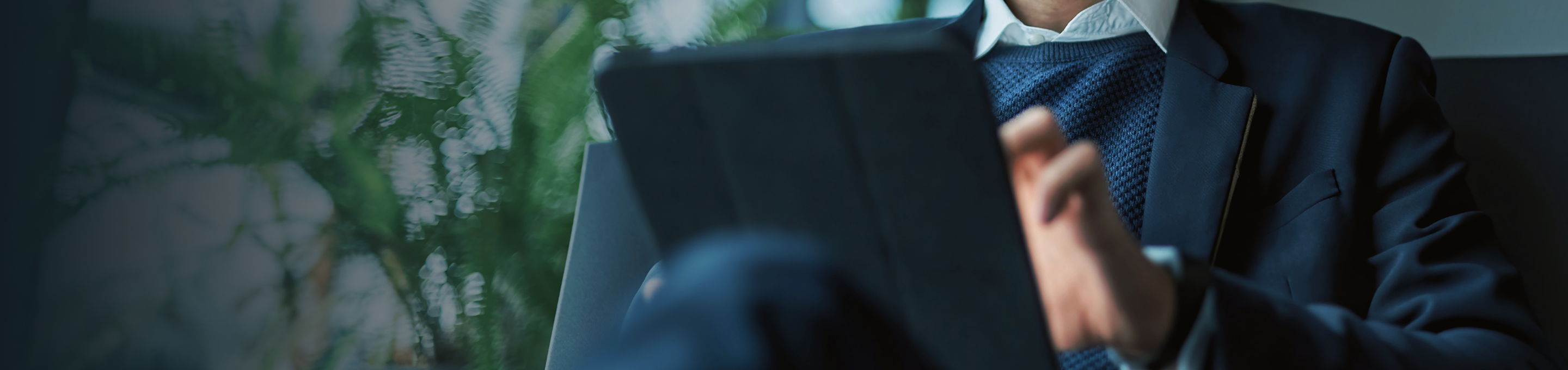 Close up of a man on his tablet.