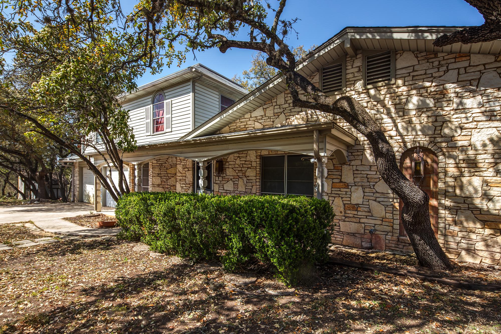 Home exterior with shrubs. Schulte Roofing of San Antonio - residential and commercial  roofing company.
