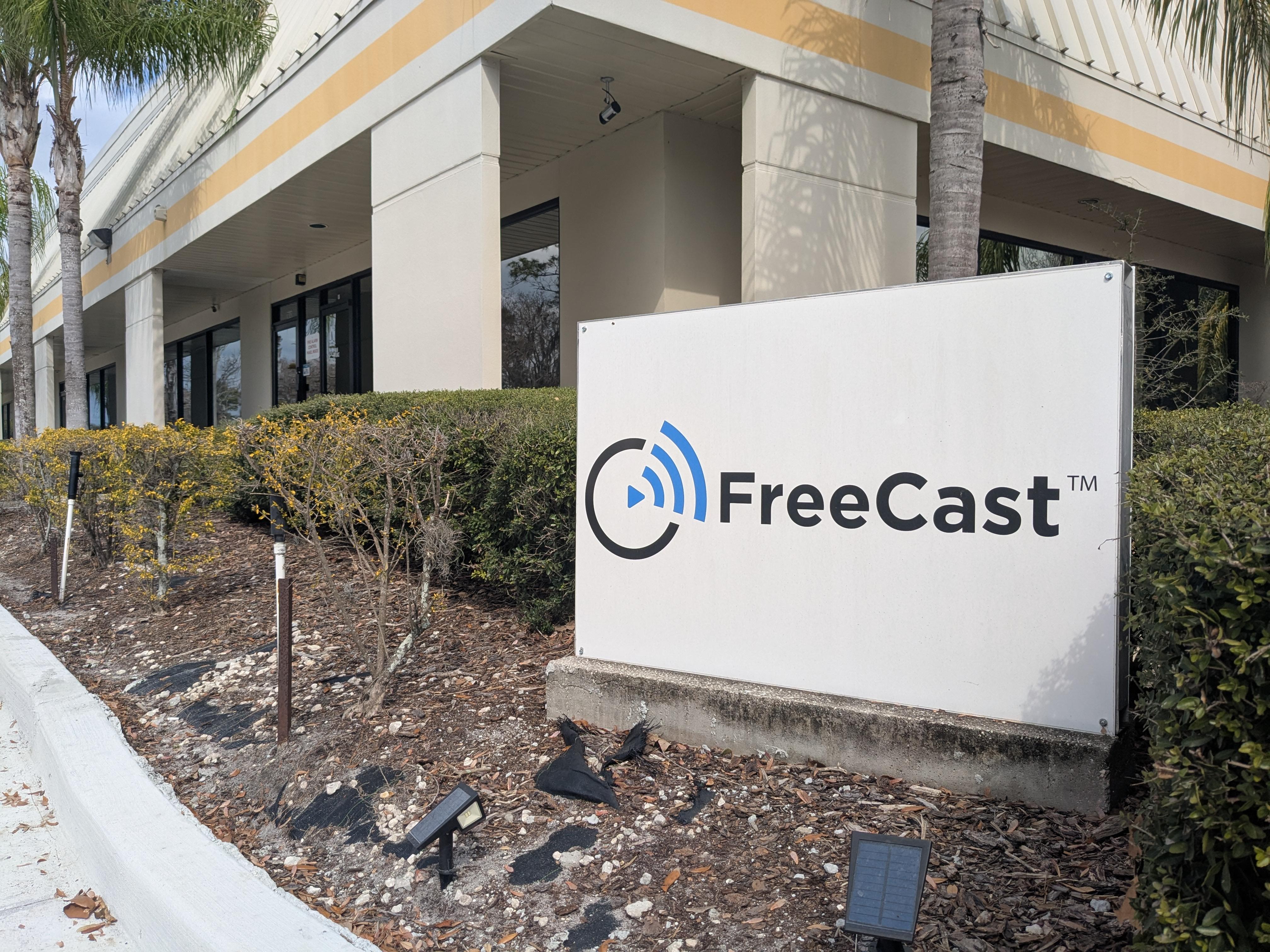 An exterior view of FreeCast, Inc.'s corporate headquarters, showcasing a prominently displayed branded sign in front of a modern office building.