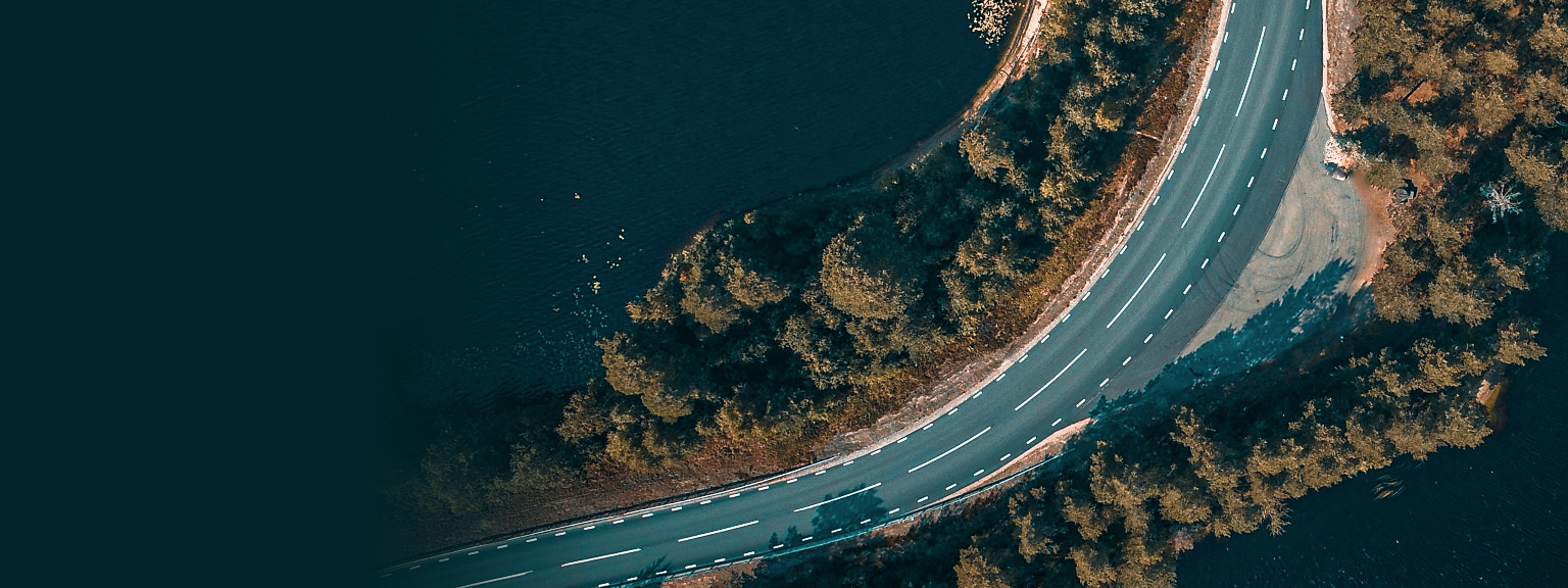 Top-down, aerial view of road on a peninsula.