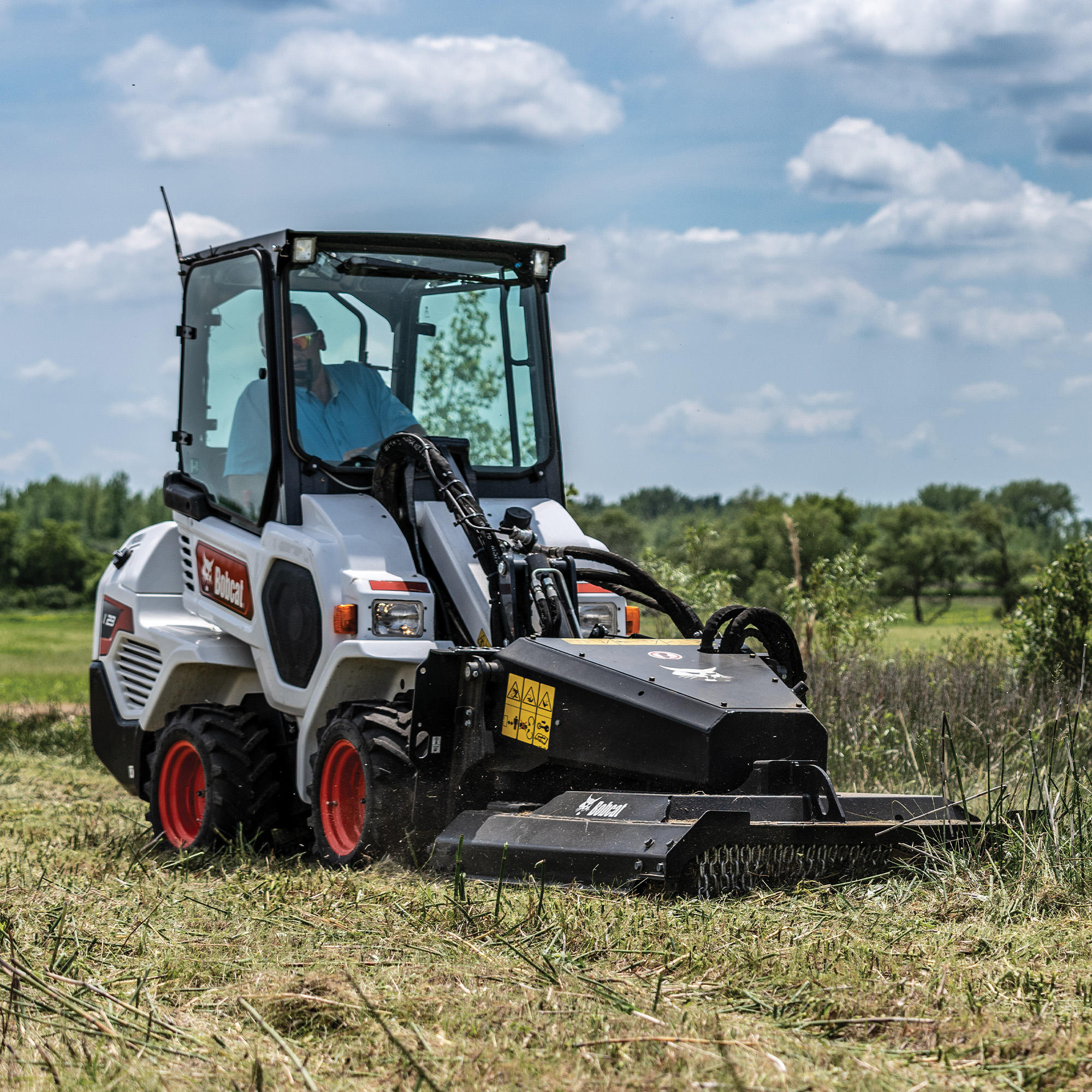 A Bobcat L23 with a Brushcat attachment Bobcat of Fort McMurray Fort Mcmurray (780)714-9200