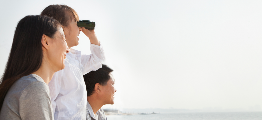 A family looking through binoculars.