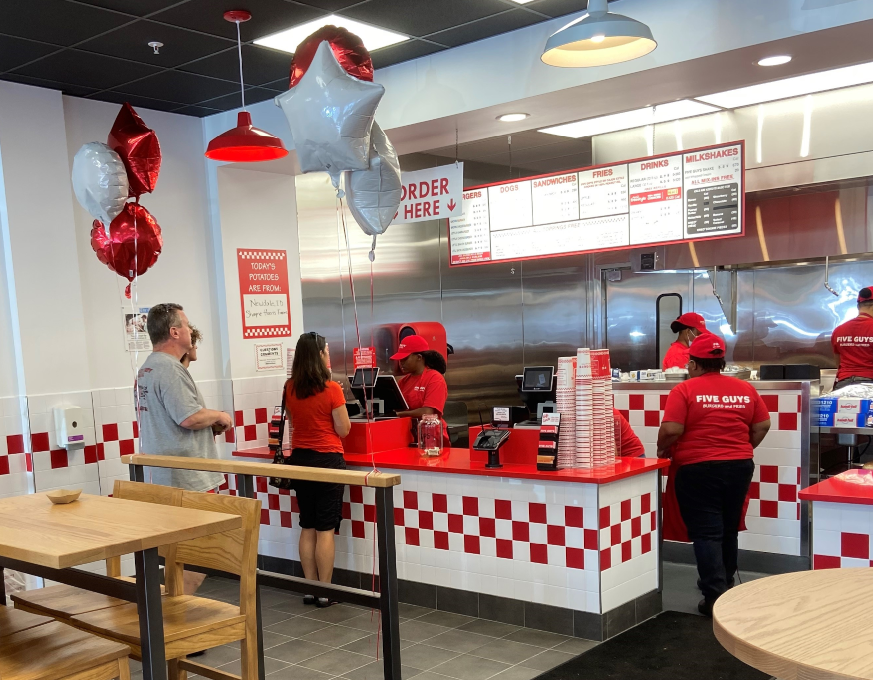 A customer places the first-ever order during the grand opening of the Five Guys at 9210 Baltimore National Pike in Ellicott City, Maryland.