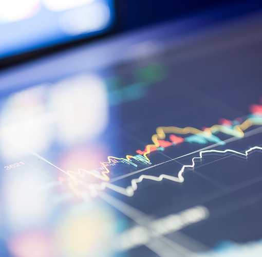 A close-up of financial charts on a screen.
