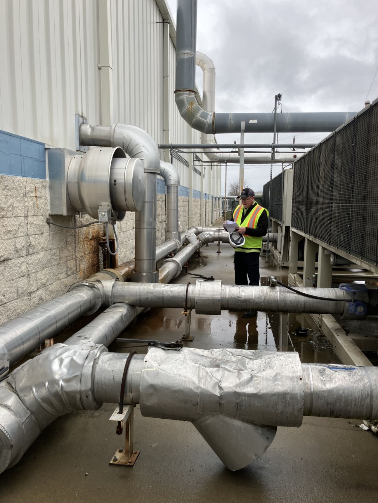 HVAC professional inspecting industrial piping