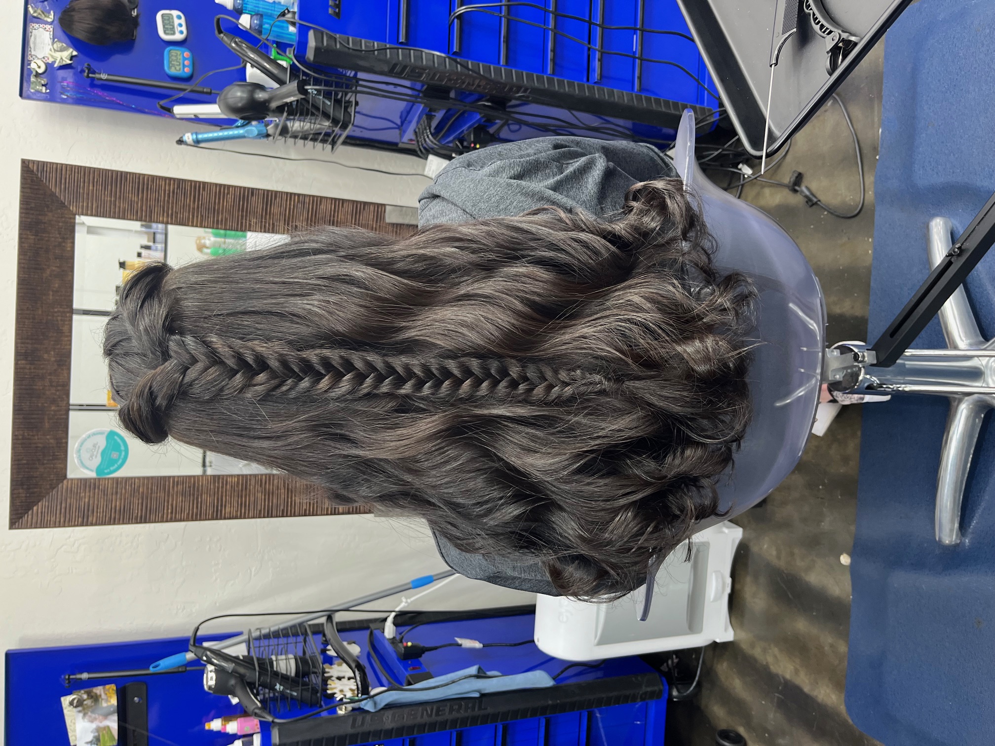 Half up braided hairstyle styled with soft curls for a polished yet effortless look. Ideal for events photos or special occasions.