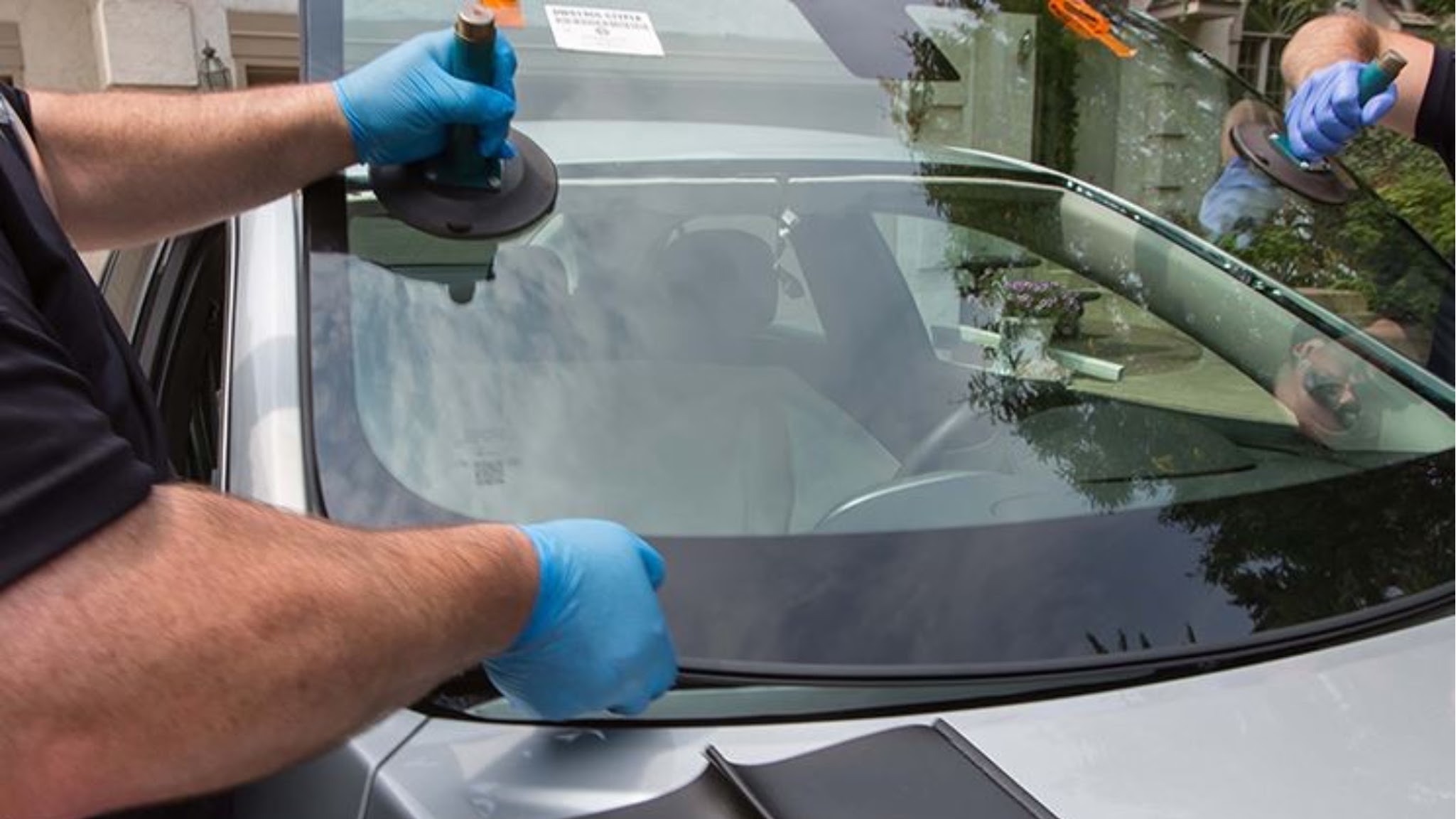 Setting a new windshield with suction cups. Lifetime warranty on our workmanship.