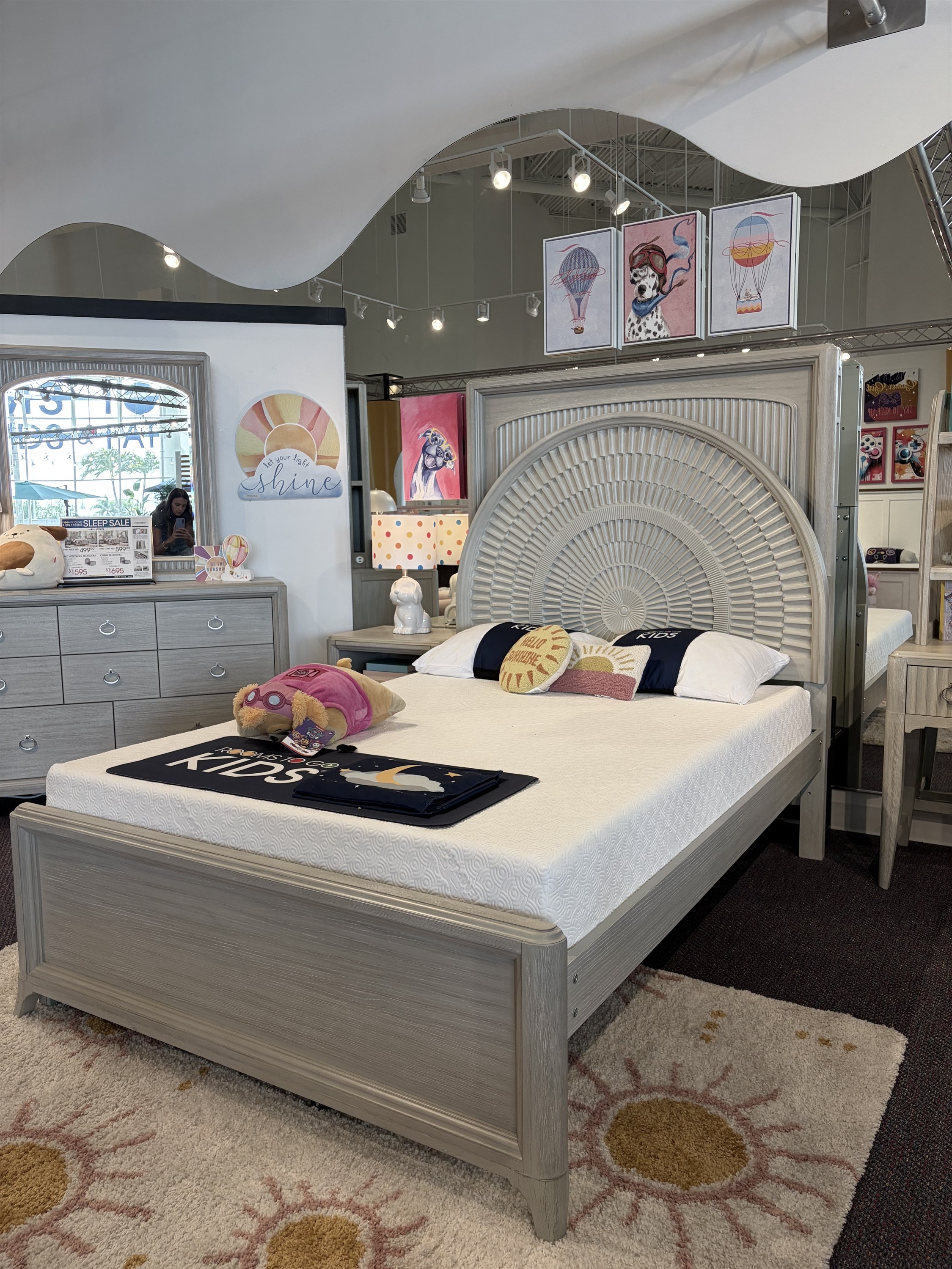 Explore this gray kids bedroom set with cream upholstered bed and arched mirror dresser