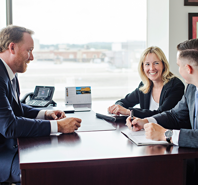 Tom Schuett, Debbie Odorico, and Liam (Boston) Coffey in the office.