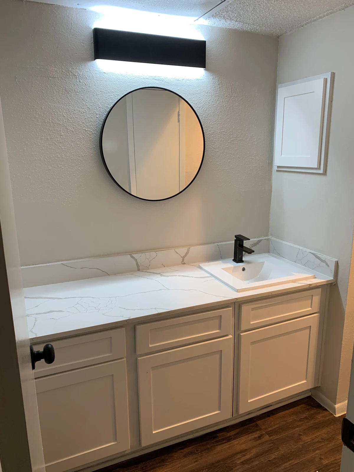 a renovated bathroom with a sink and a mirror