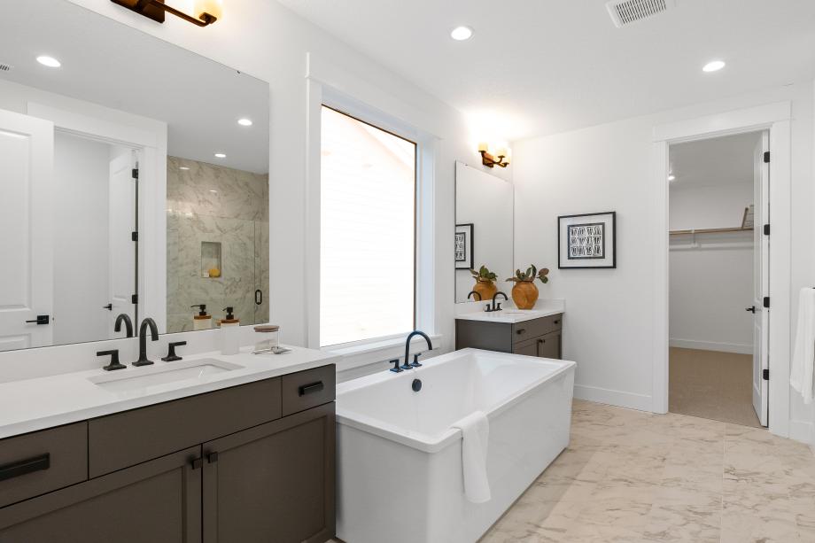 Enjoy separate vanities and a free-standing soaking tub in the Springhill home design