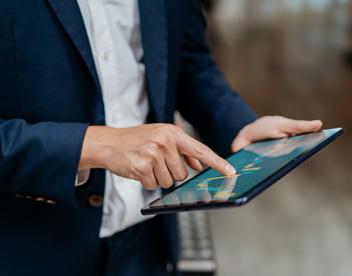 A close up of an advisor looking at graphs on their iPad.