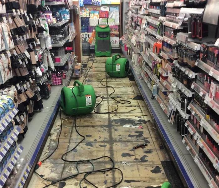 This flood created serious damages for this local pharmacy. You can see the floors have been pulled up in multiple places and we have plenty of fans on the scene. Sometimes we have to work in small active places like these and we make sure our customers can carry on with their days while our equipment is there.