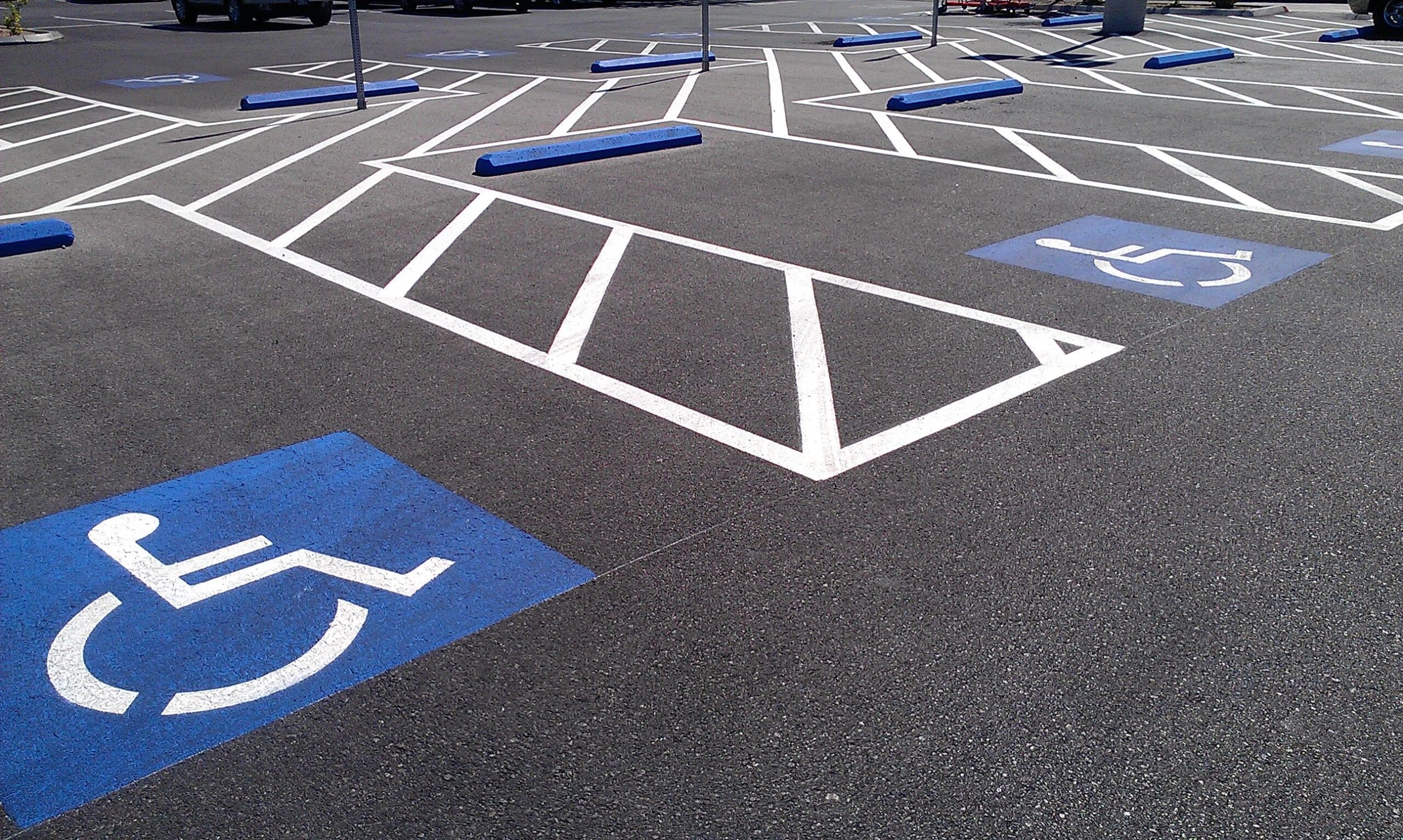 Commercial parking lot ADA handicap marking and striping, improving accessibility, safety, and compliance.