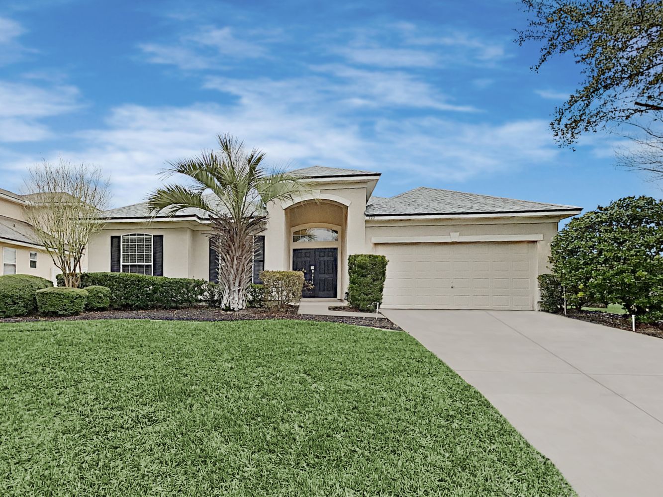Gorgeous home with a long driveway and two-car garage at Invitation Homes Jacksonville.