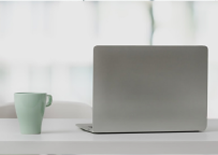Laptop and mug in a sleek office setting.