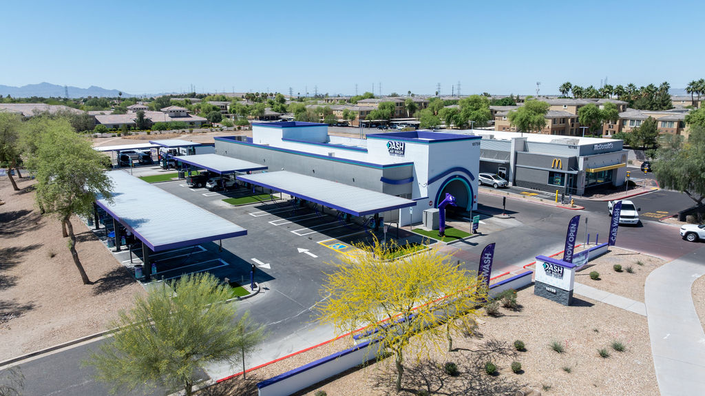 Aerial view of DASH Car Wash Olive Ave featuring our express wash tunnel, complimentary vacuum stati 