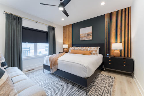 Doesn’t this feel luxurious? We love the combination of drapery and black roller shades! The two window coverings together offer ample privacy, light control, and style in this chic bedroom.