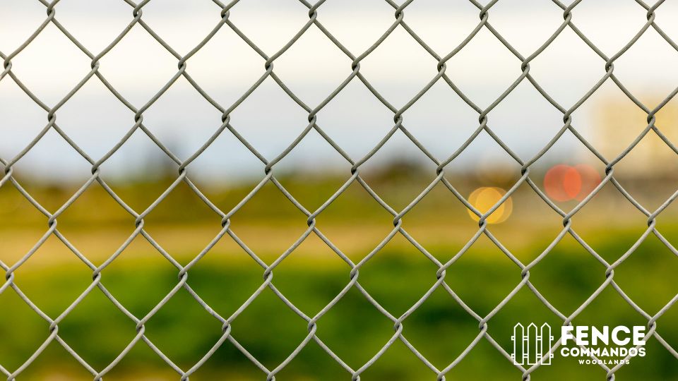 Close-up of durable galvanized chain-link fencing installed by Fence Commandos Woodlands.