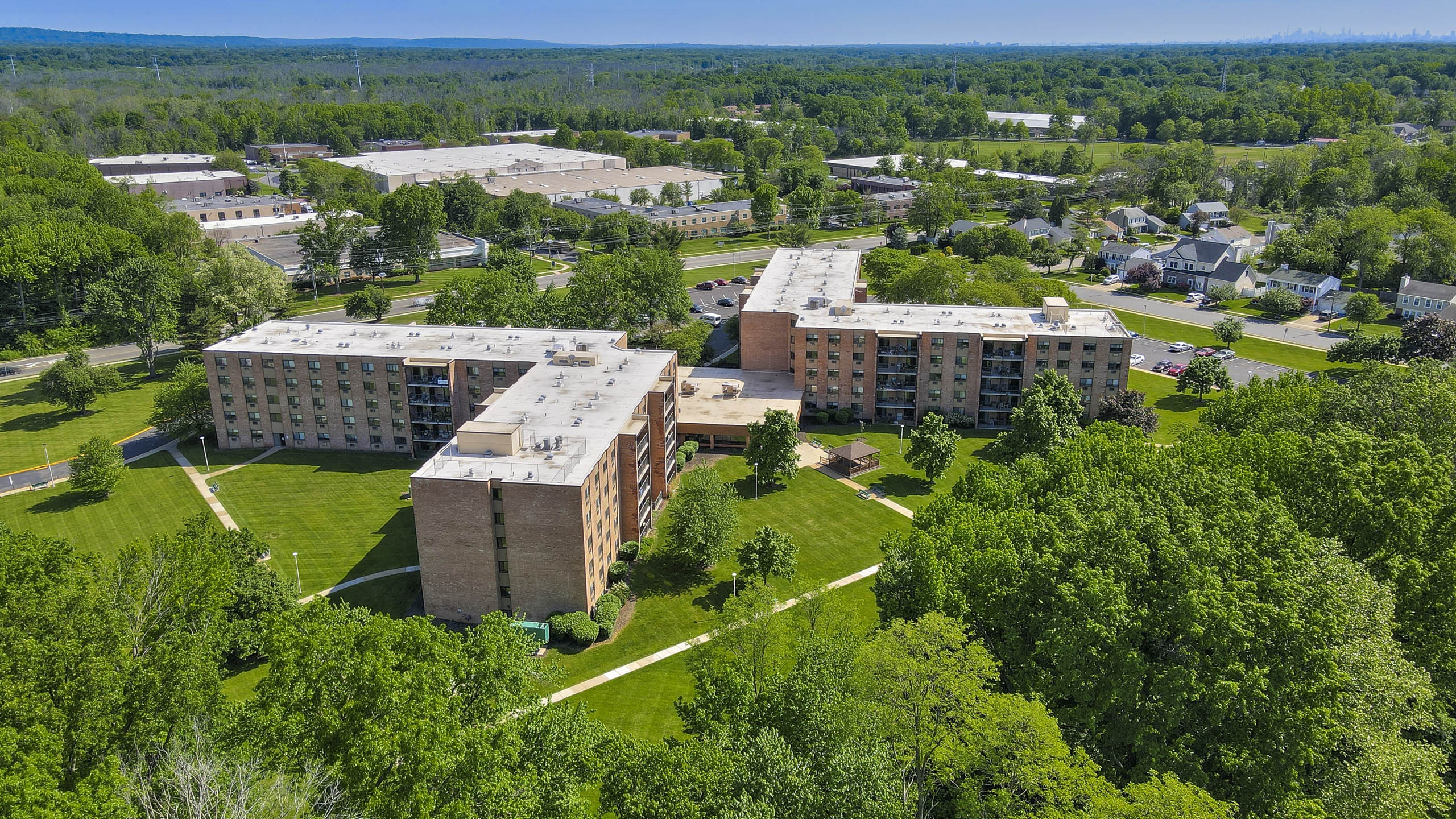 A large building complex surrounded by trees.
