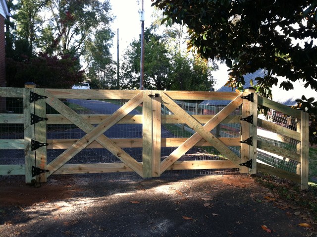 Four board fence with wire and custom double gate