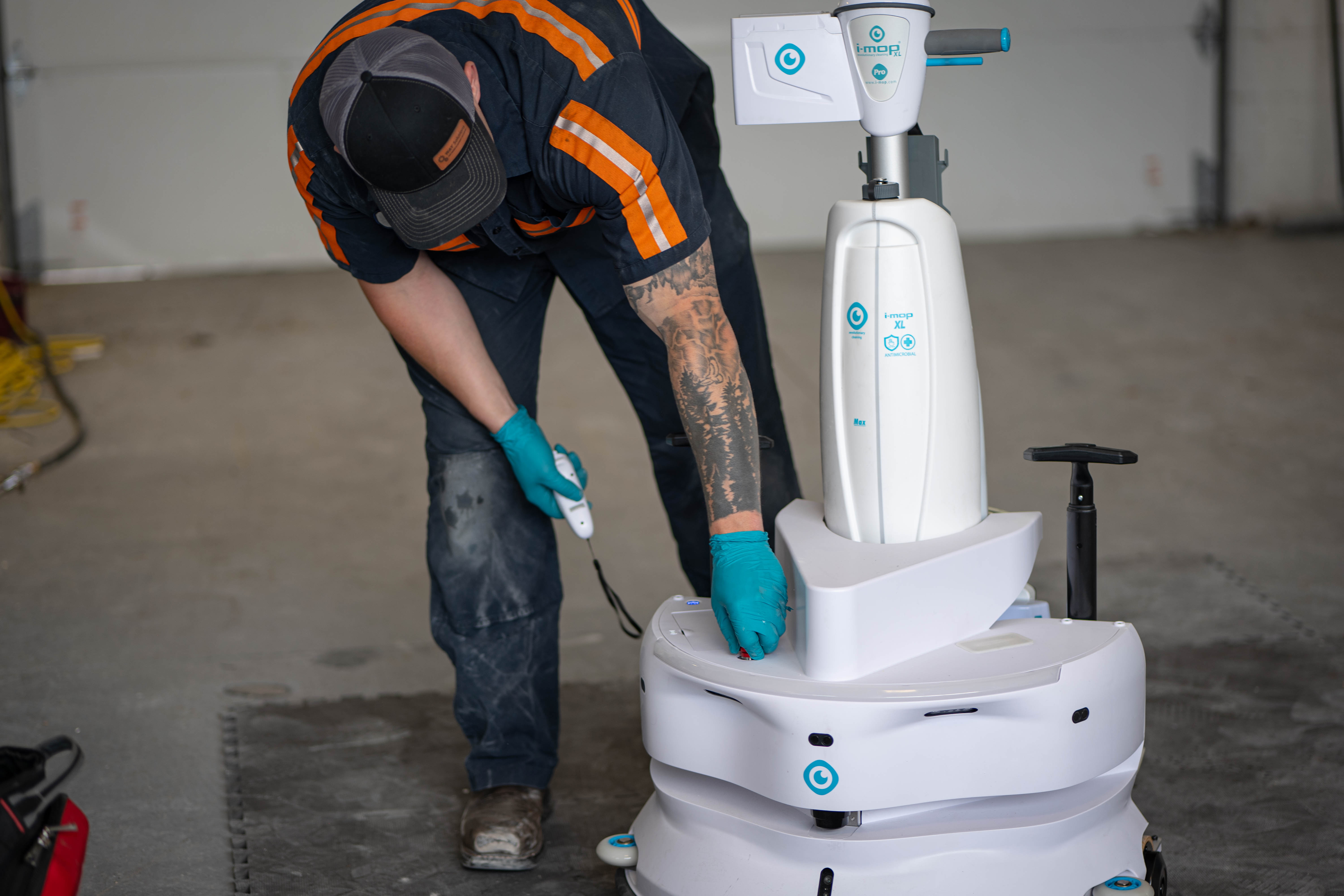A WaySolutions service technician performs advanced calibration and diagnostic testing on the base of a high-tech i-mop XL commercial floor scrubber. We provide specialized maintenance for modern smart cleaning equipment, ensuring precise operation and reliability for commercial facilities in Layton, Utah