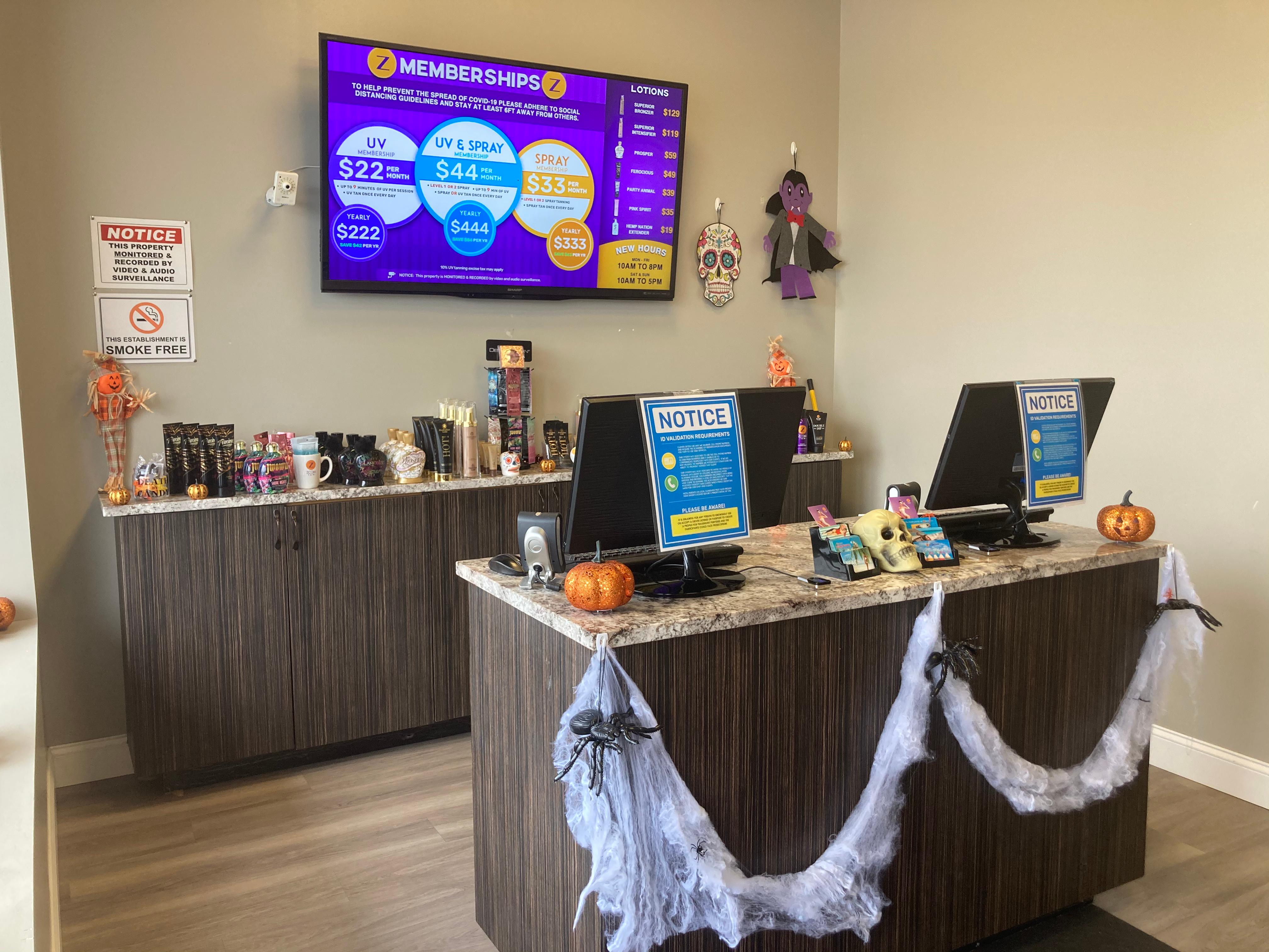 Zoom Tan front counter with Halloween decorations in Glenville, NY