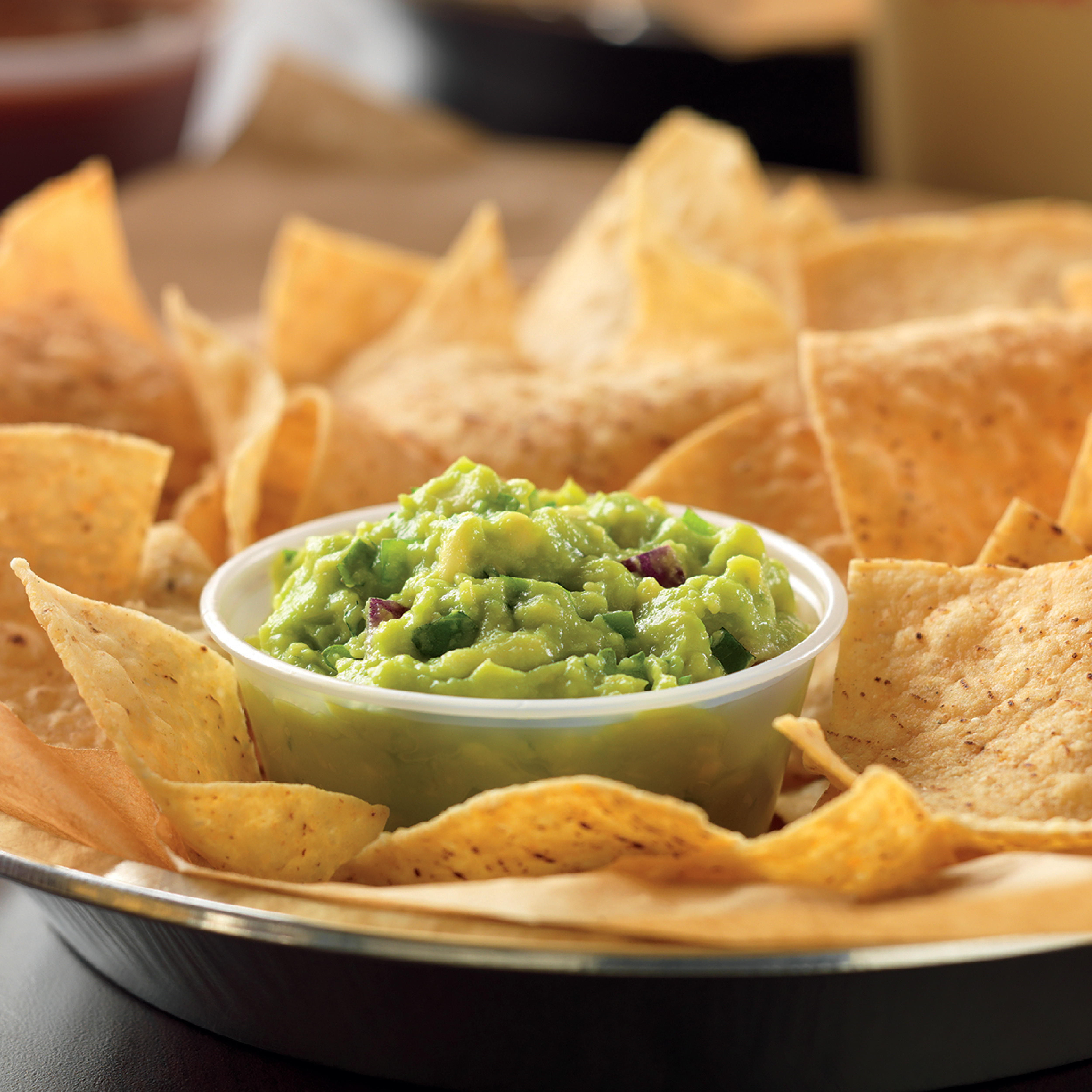 Hand-smashed-in-house-daily guacamole is best served with freshly fried in-house tortilla chips.