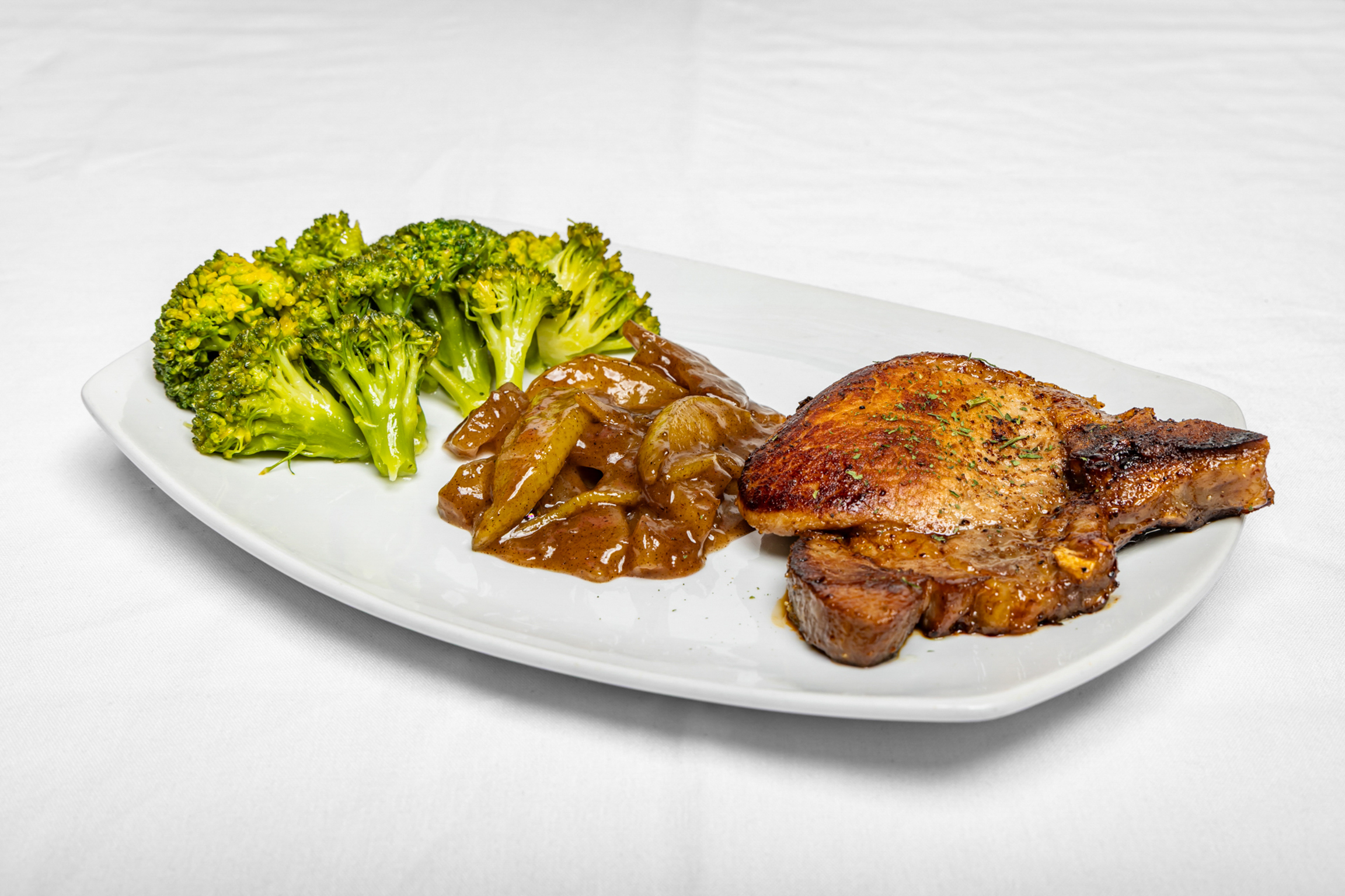 Seasoned and seared pork chop, tender and flavorful, served hot and satisfying.