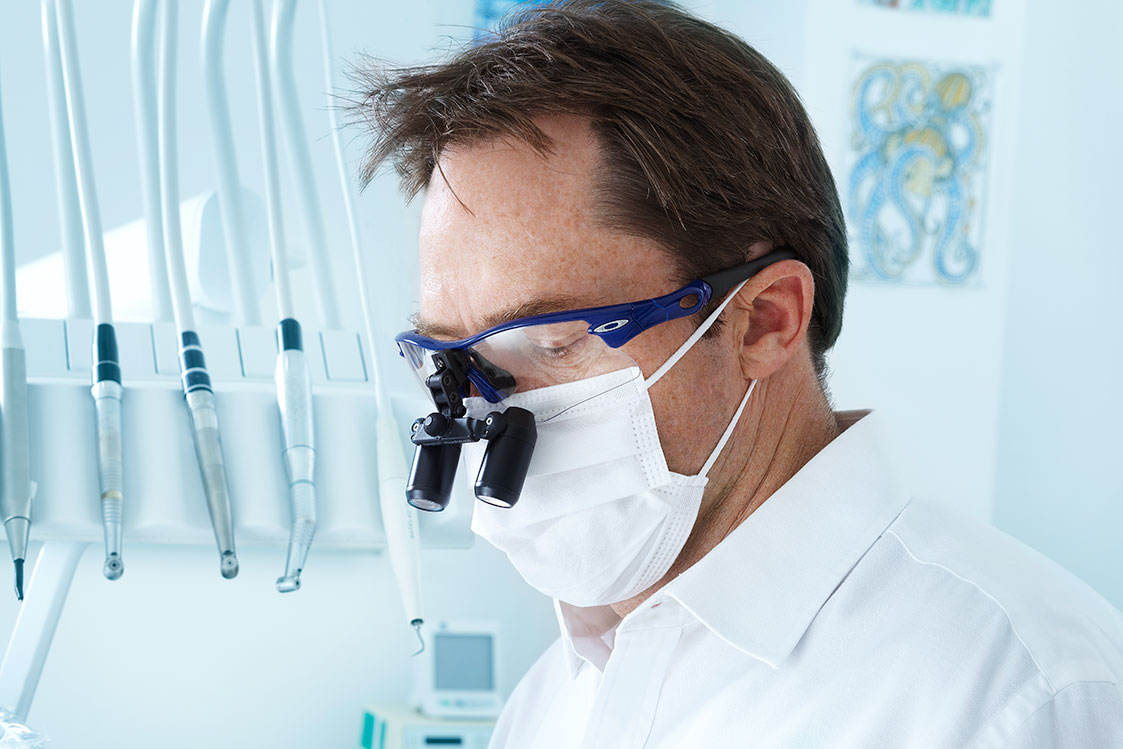 man wearing loupes while working