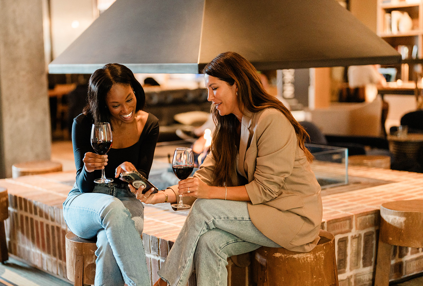 Guests gather around the fire at The Trade Room, the lobby bar at The Junto in downtown Columbus. 