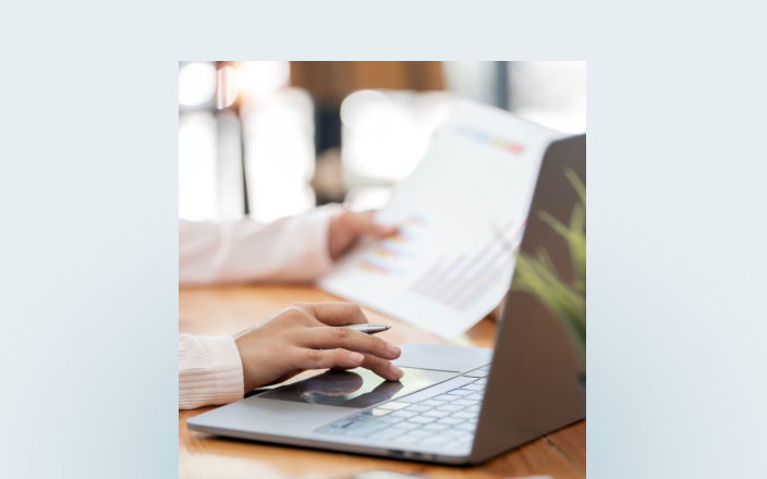 Close up of a professional typing on their laptop.