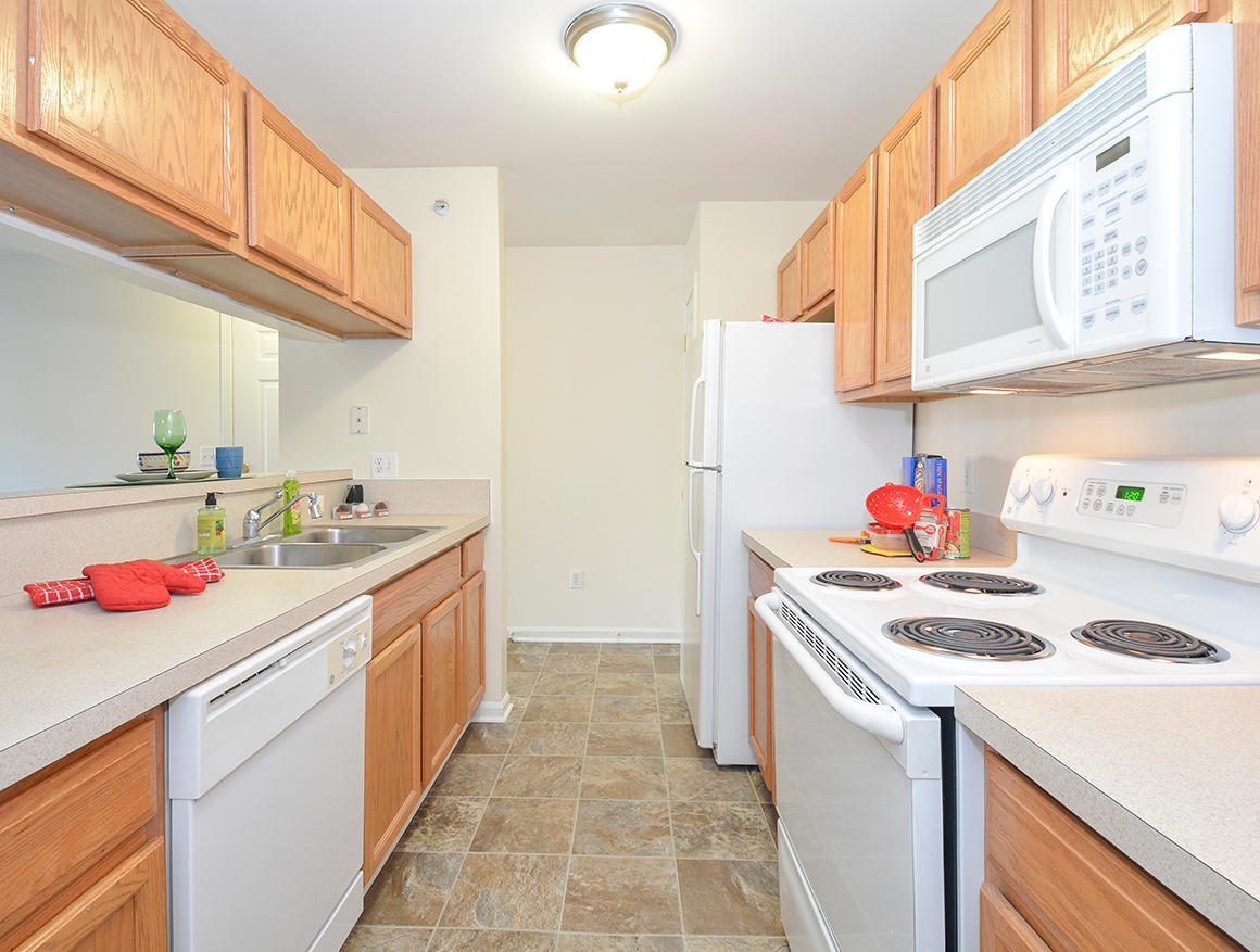 Fully-Equipped Kitchen With White Appliances